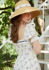 Close-up of the floral print and lace trim on a midi dress.