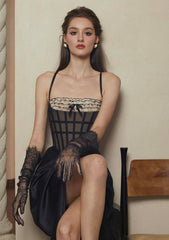 Back view of a black satin dress with a lace-up corset bodice