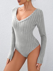 Close-up front view of a grey ribbed long-sleeve bodysuit.