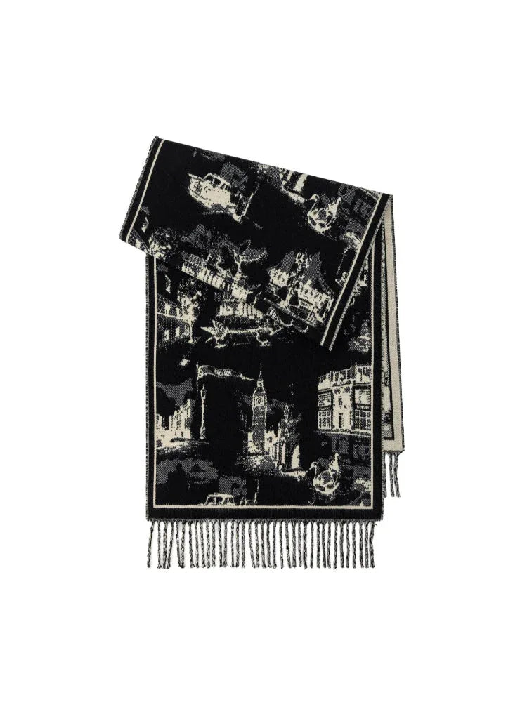 A folded black and white patterned scarf with a city landscape print and fringed edges