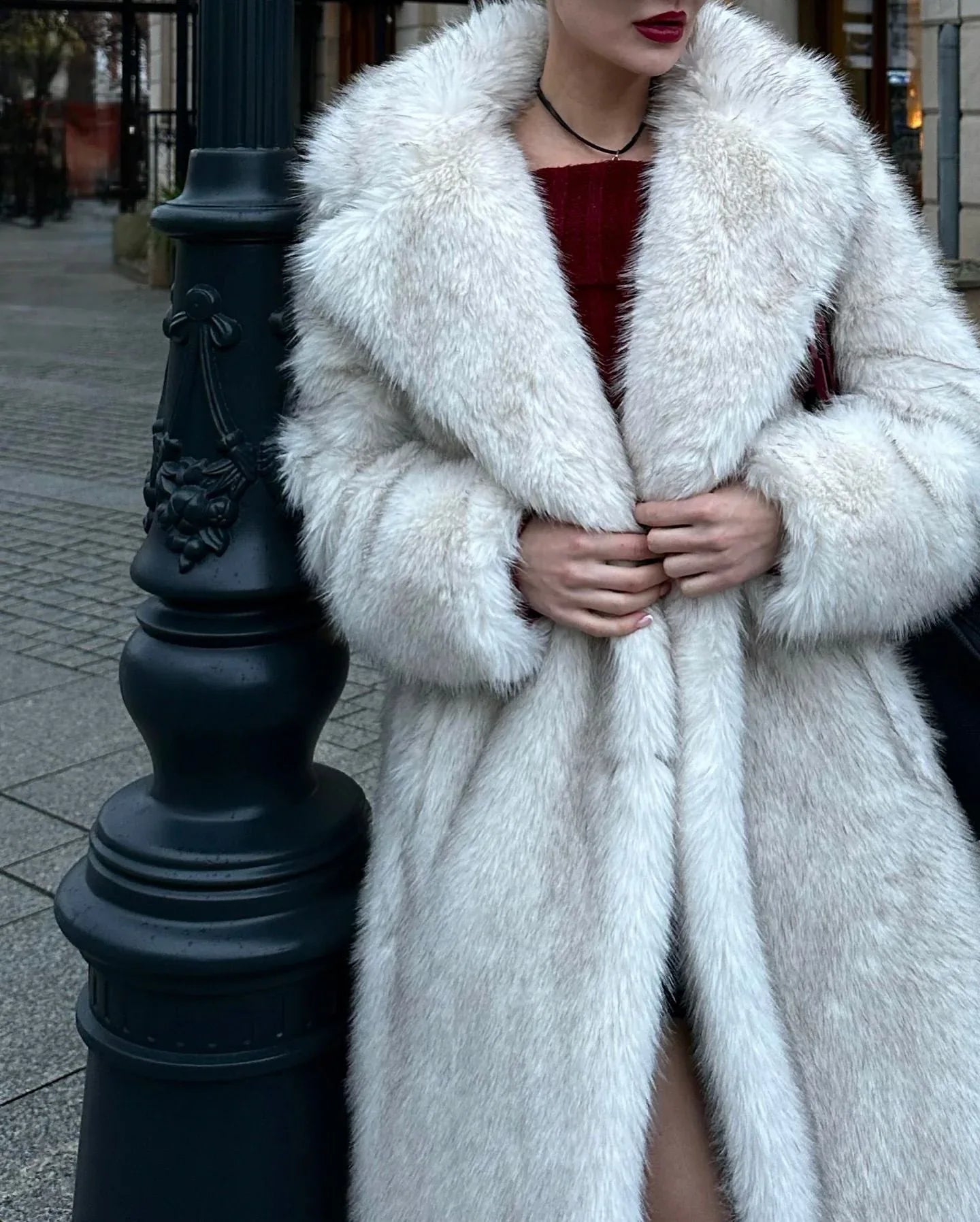 Close-up of a woman wearing a white faux fur coat