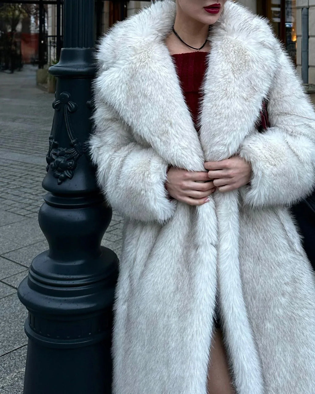Close-up of a woman wearing a white faux fur coat