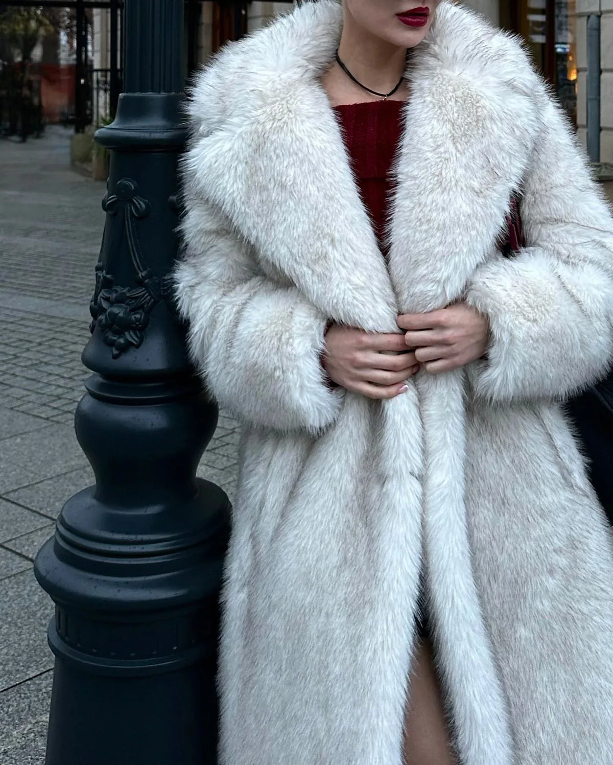 Close-up of a woman wearing a white faux fur coat