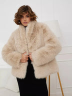 Woman wearing a beige faux fur jacket and black skirt