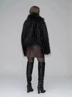 Back view of a woman in a black faux fur jacket, brown wrap dress, sheer black tights, and black knee-high boots.