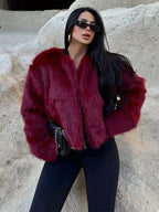 Front view of a woman in a burgundy faux fur cropped jacket