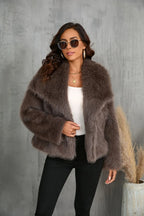 Close-up of a woman wearing a brown faux fur jacket, white top, and black pants.