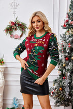 Woman in a festive Christmas sweater posing with hands tucked in.