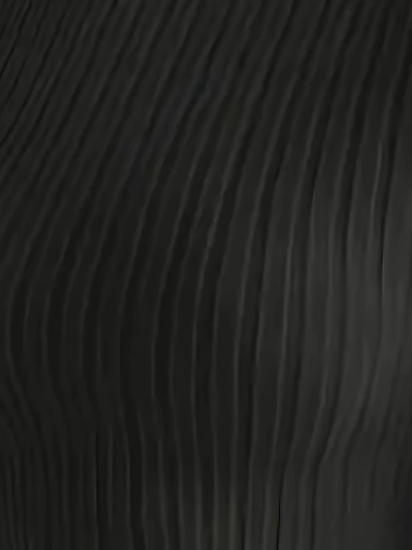 Close-up of the ribbed texture of the black knit fabric of the long-sleeve top.