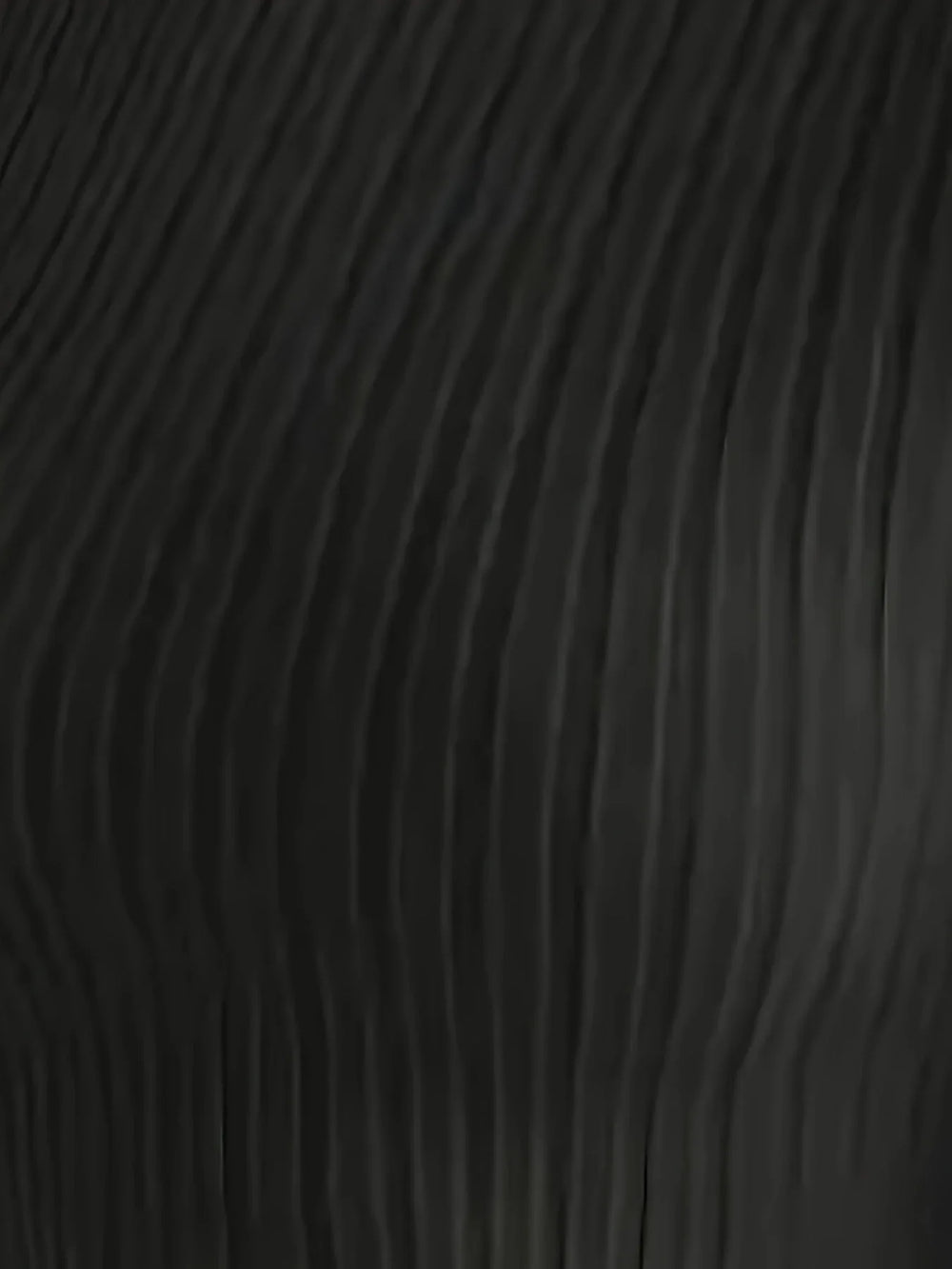 Close-up of the ribbed texture of the black knit fabric of the long-sleeve top.