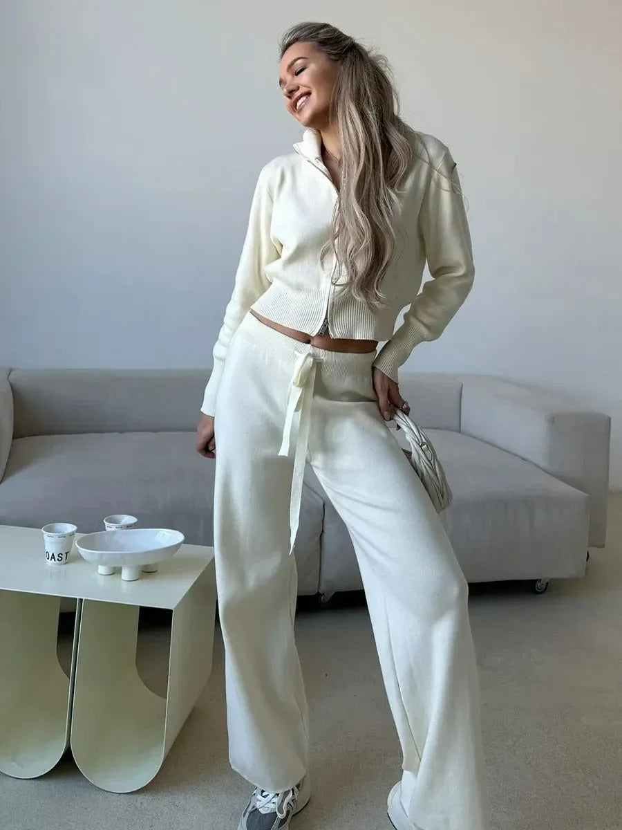 Woman smiling and posing in a cream knit loungewear set