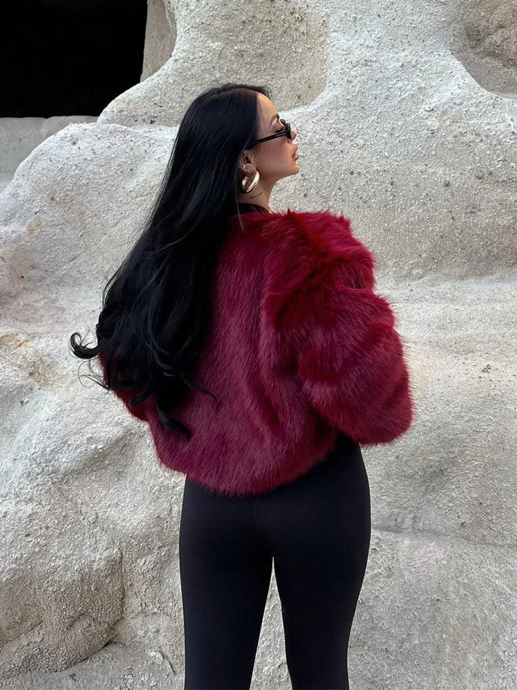 Back view of a woman wearing a burgundy faux fur cropped jacket