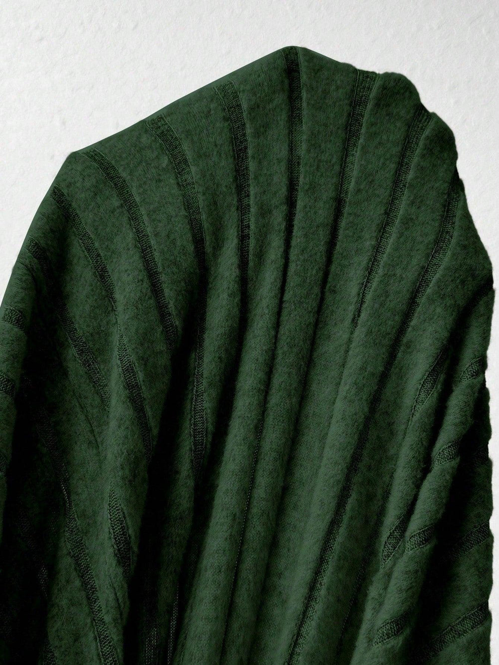 Close-up of the green ribbed knit fabric of a dress.