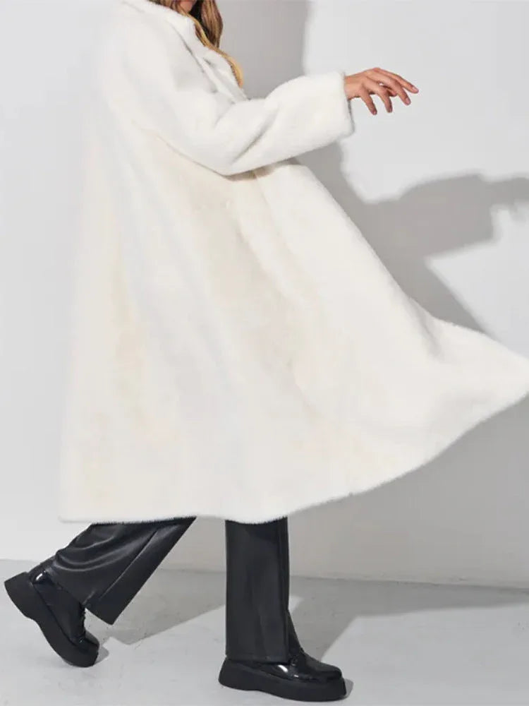 Model twirling in a white faux fur coat