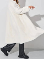 Model twirling in a white faux fur coat