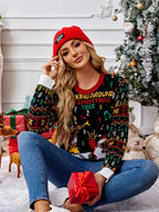 Woman wearing a red beanie and a black Christmas sweater with a graphic of Santa playing guitar and a reindeer, sitting on the floor with gifts and decorations.