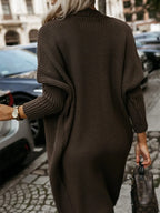 Back view of a woman wearing a long brown knit cardigan.