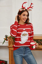 Woman wearing a red striped Christmas sweater with a sequin Santa Claus graphic, holding a Santa mug.