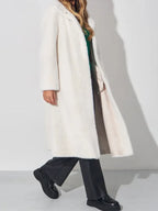 Side view of a model in a white faux fur coat