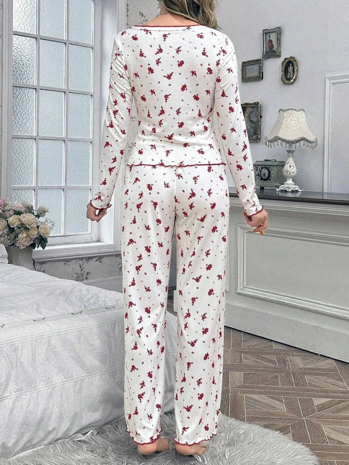 Back view of a woman wearing white floral print pajamas