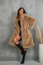 Woman wearing a tan faux fur coat with black shorts and boots