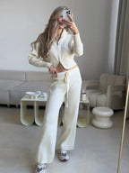 Woman taking a mirror selfie in a cream knit loungewear set