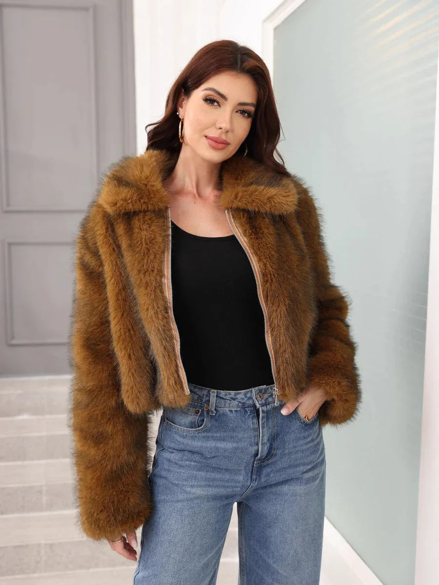 Front view of a woman wearing a brown faux fur cropped jacket, black top, and blue jeans.