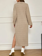 Back view of a woman wearing a beige ribbed knit midi dress with a collared V-neck and long sleeves, showcasing a side slit.