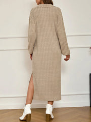 Back view of a woman wearing a beige ribbed knit midi dress with a collared V-neck and long sleeves, showcasing a side slit.