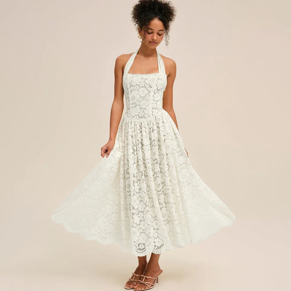 Model posing in a white lace halter midi dress