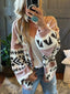 woman in a pink and black geometric print knit cardigan