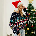 Close-up of a woman's profile, wearing a Christmas-themed knit sweater and a Santa hat, with a Christmas tree in the background.