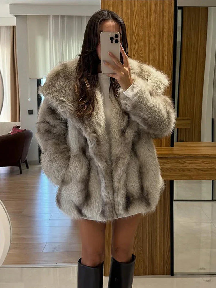 full body shot of a woman wearing a light brown oversized faux fur coat and black boots