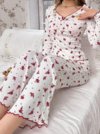 Woman sitting on a bed wearing white floral print pajamas