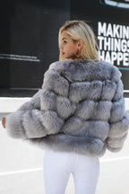 Back view of a woman in a grey faux fur jacket