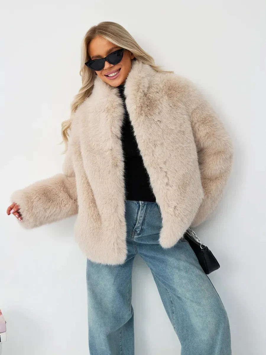 Woman wearing a beige faux fur jacket and blue jeans