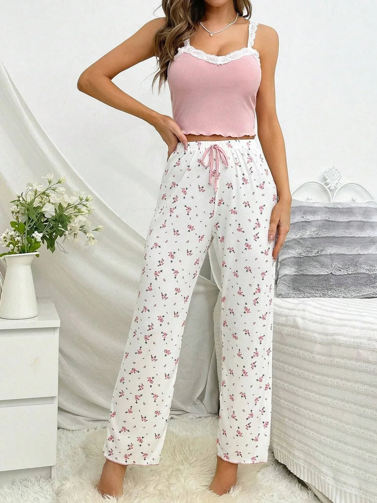 woman posing in pink floral pajama set