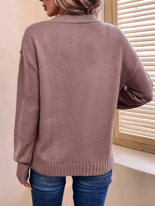 Back view of a woman wearing a mauve knit sweater with a mock neckline and long sleeves.