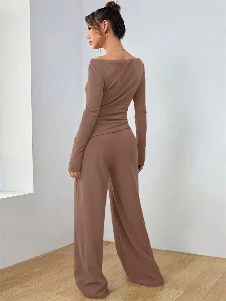 Woman wearing a brown long-sleeve top and wide-leg pants set, standing and showing the back view.