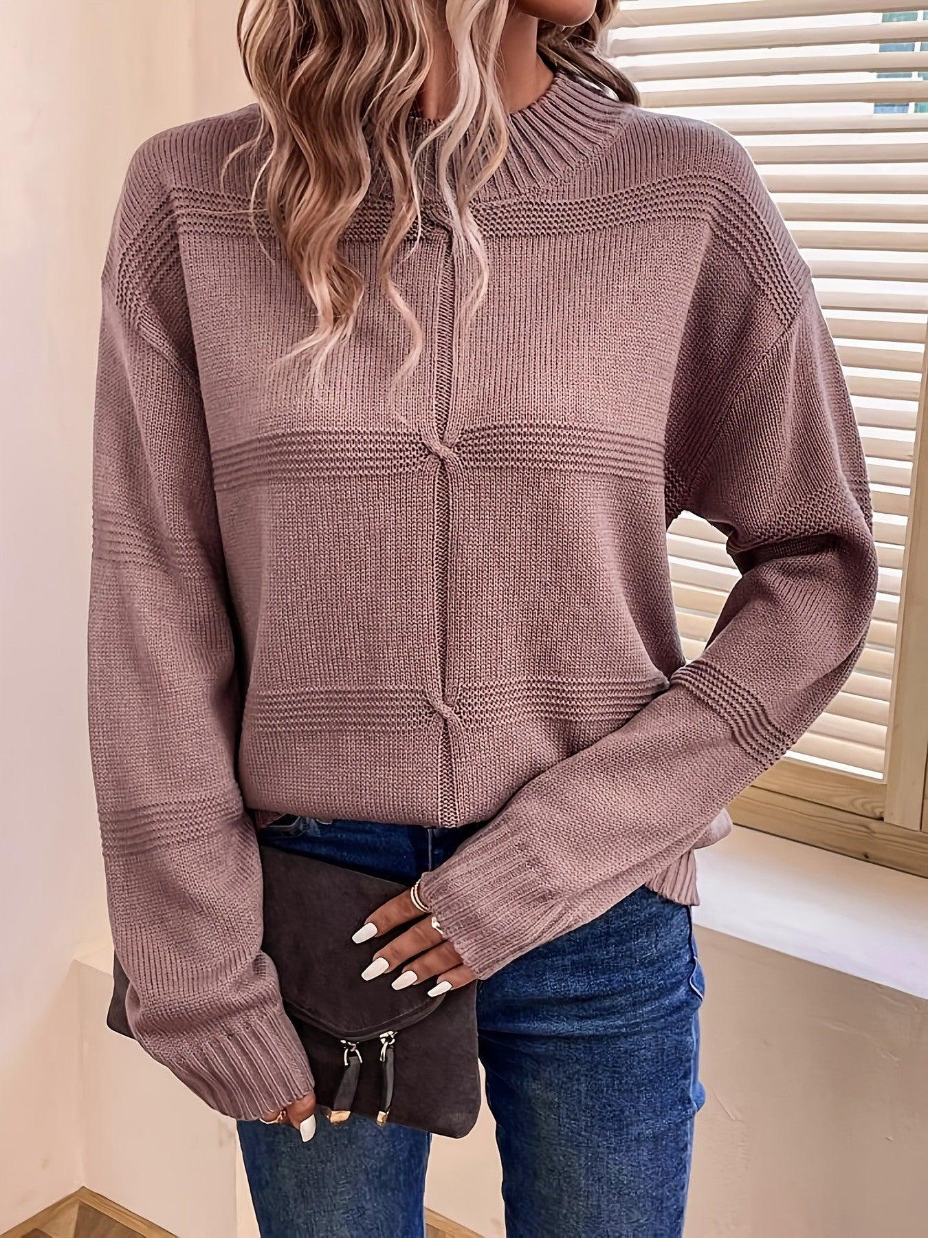 Woman in a mauve knit sweater with a mock neckline and long sleeves, showing the detail of the knot accent.