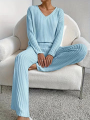 Woman sitting in a chair wearing a light blue ribbed loungewear set