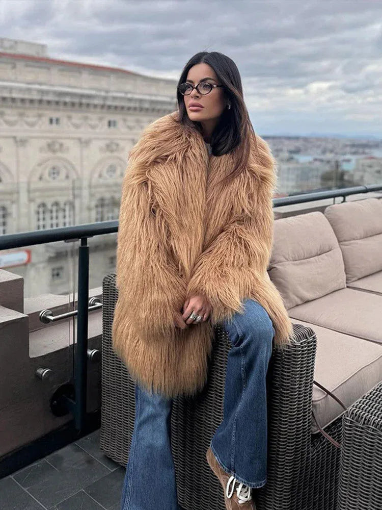 woman wearing a shaggy brown faux fur coat and blue jeans Main image