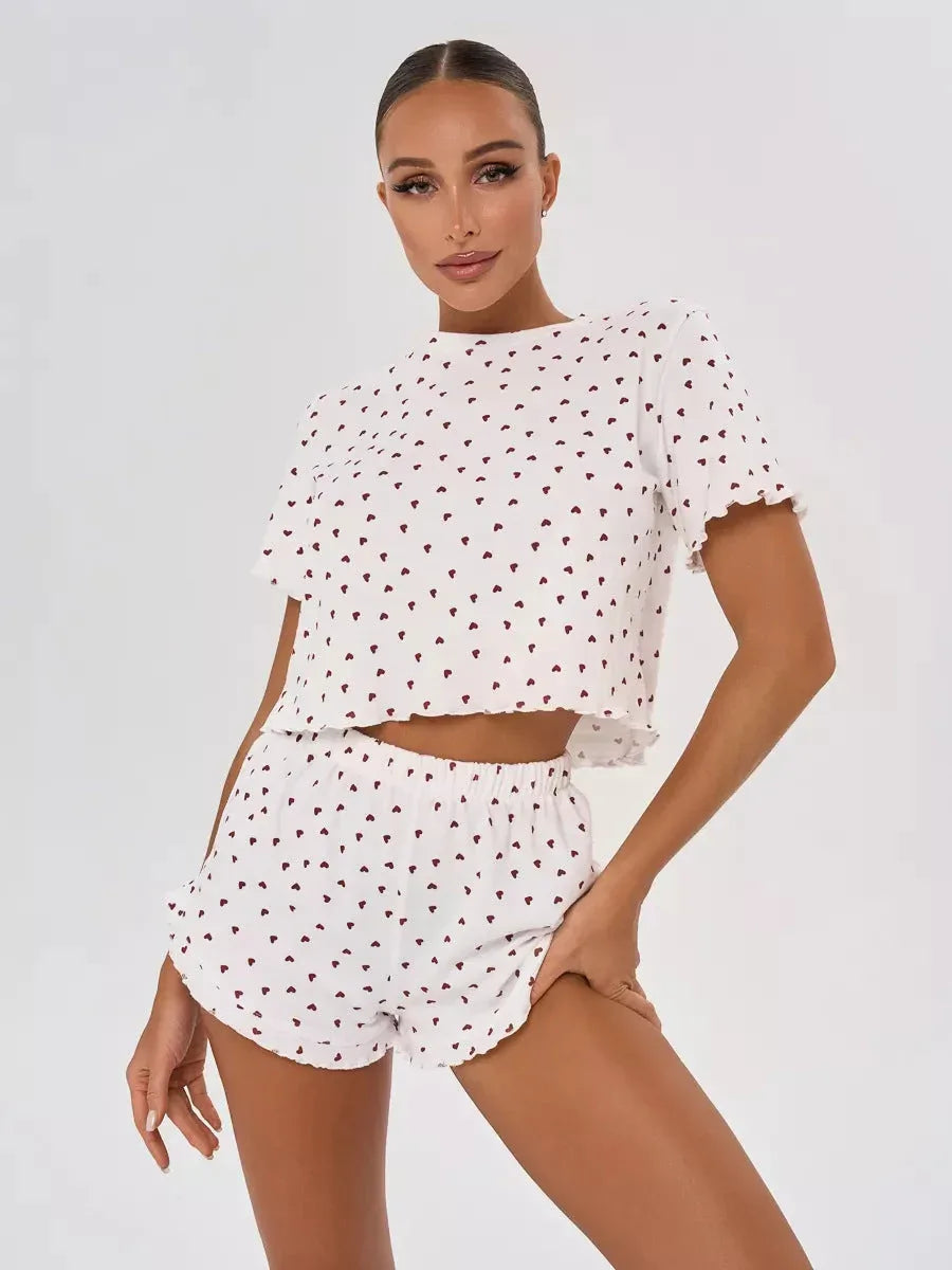 Woman wearing a white cropped t-shirt and shorts with a red heart print. Main image