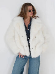 Close-up of the front of a white faux fur jacket worn by a woman.