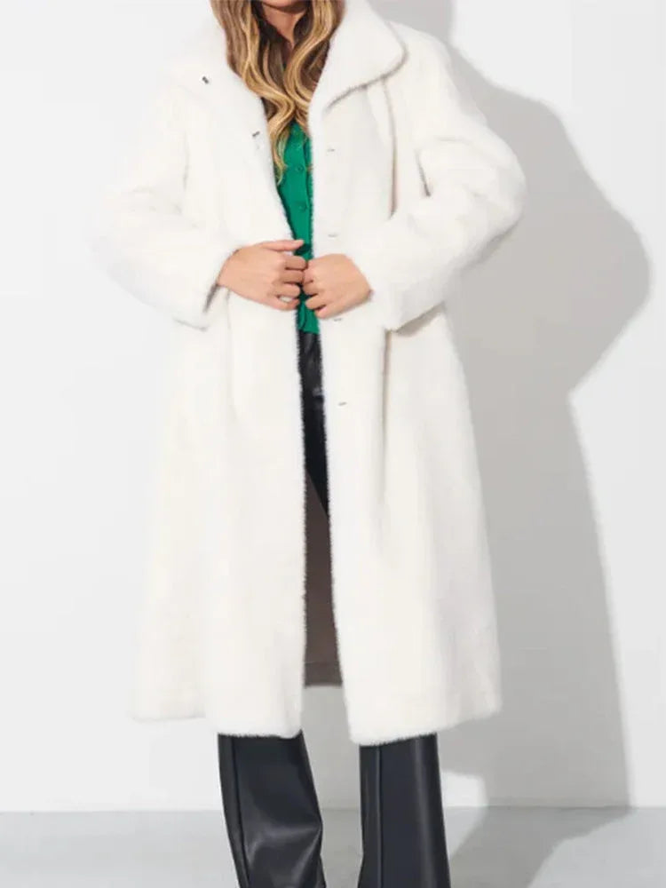 Model wearing a long white faux fur coat