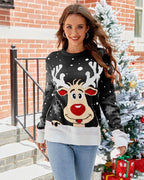 Woman wearing a black knit sweater with a reindeer graphic and snowflakes