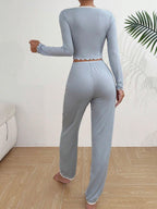 Back view of a woman in a light blue ribbed knit pajama set.