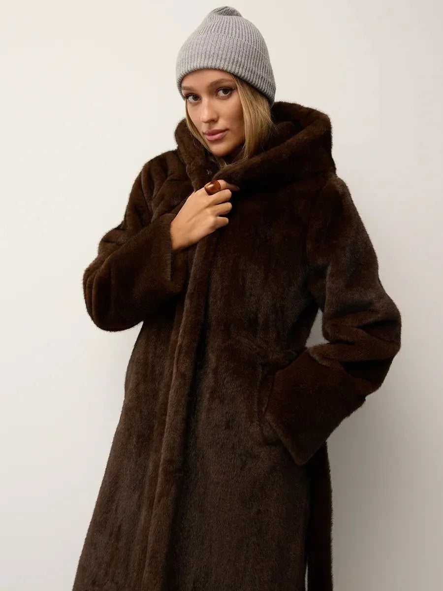Woman wearing a brown hooded faux fur coat with a grey beanie.