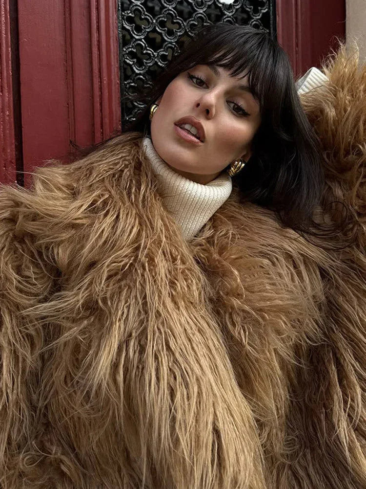 close-up of a woman wearing a shaggy brown faux fur coat and a white turtleneck