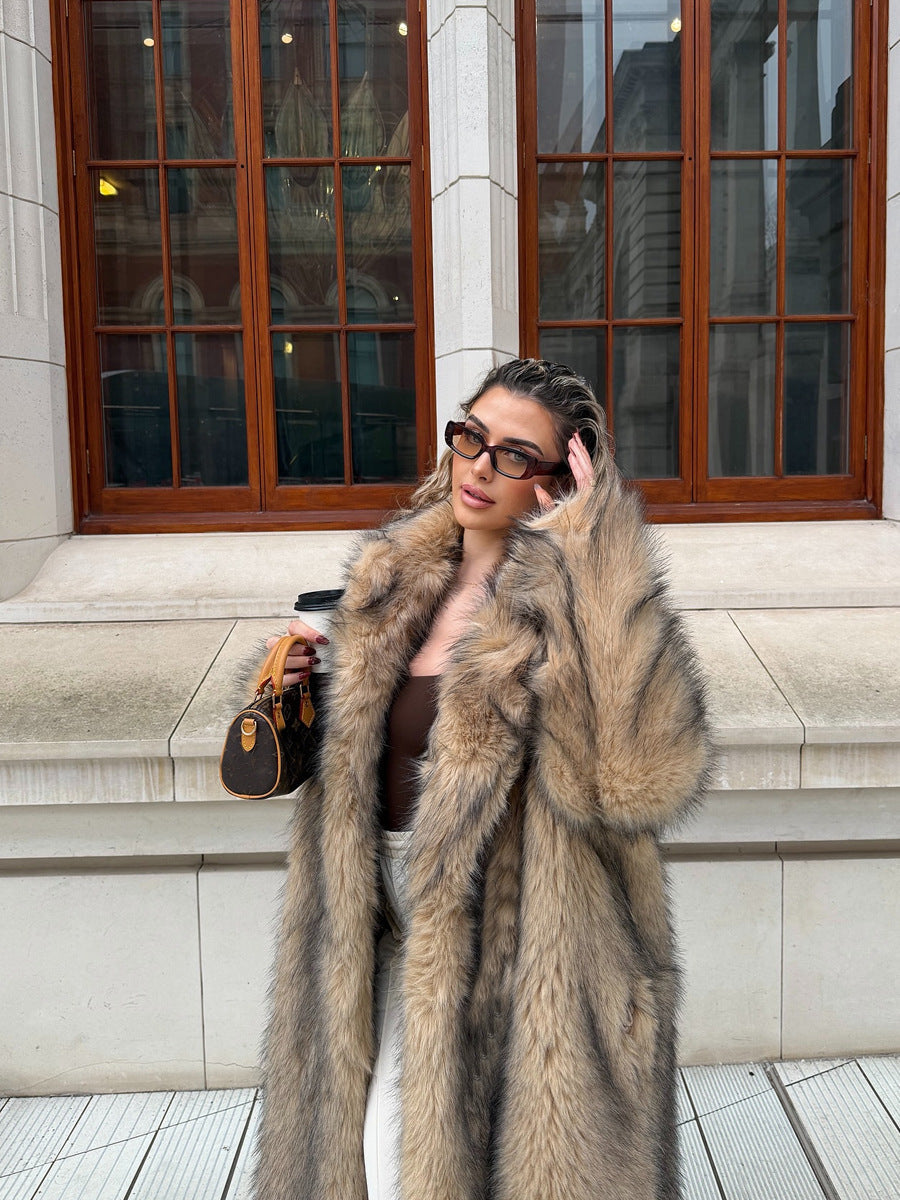 Fashionable woman in a statement faux fur coat, styled with sunglasses and a small handbag.